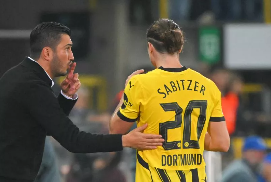 Borussia Dortmund's Turkish coach Nuri Sahin (L) speaks with Borussia Dortmund's Austrian midfielder #20 Marcel Sabitzer