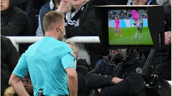 Referee Samuel Barrott consults the VAR monitor at Newcastle United